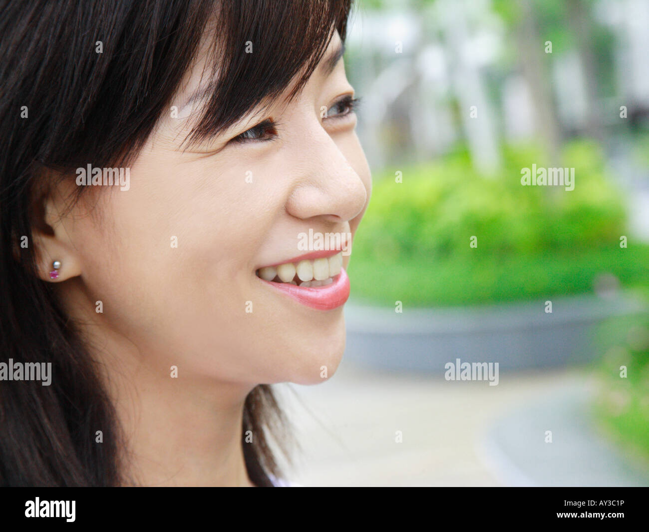 Side profile of a mid adult woman smiling Stock Photo - Alamy