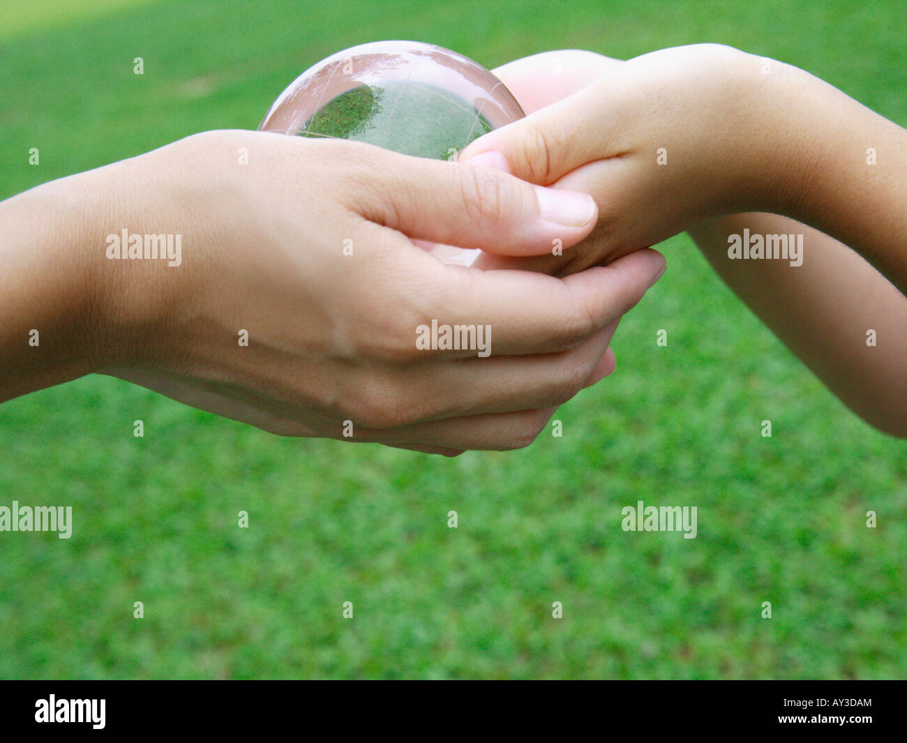 Two people holding up globe hi-res stock photography and images - Alamy