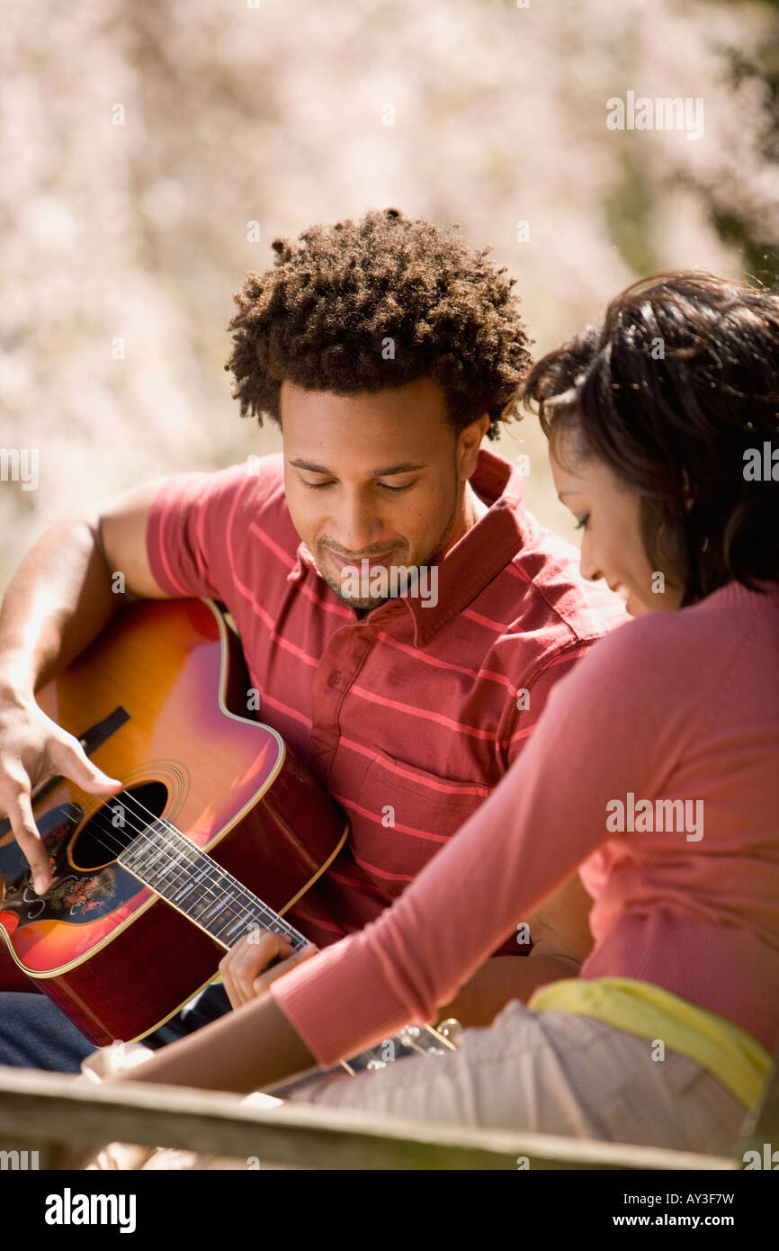 African American man playing guitar for girlfriend Stock Photo - Alamy