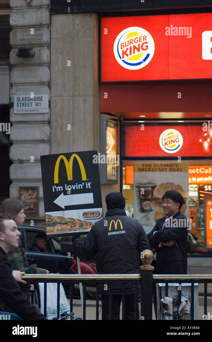 Give Me Directions To Mcdonald S Man Holding Sign With Directions To Mcdonalds Outside A Burger King  Piccadilly Circus London Stock Photo - Alamy