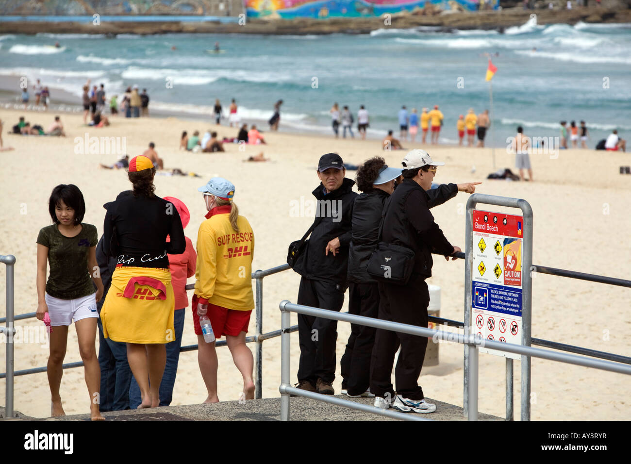 Tourists wrapped up, watch the activity on Bondi Beach,Easter Saturday 2008,sydney,australia Stock Photo
