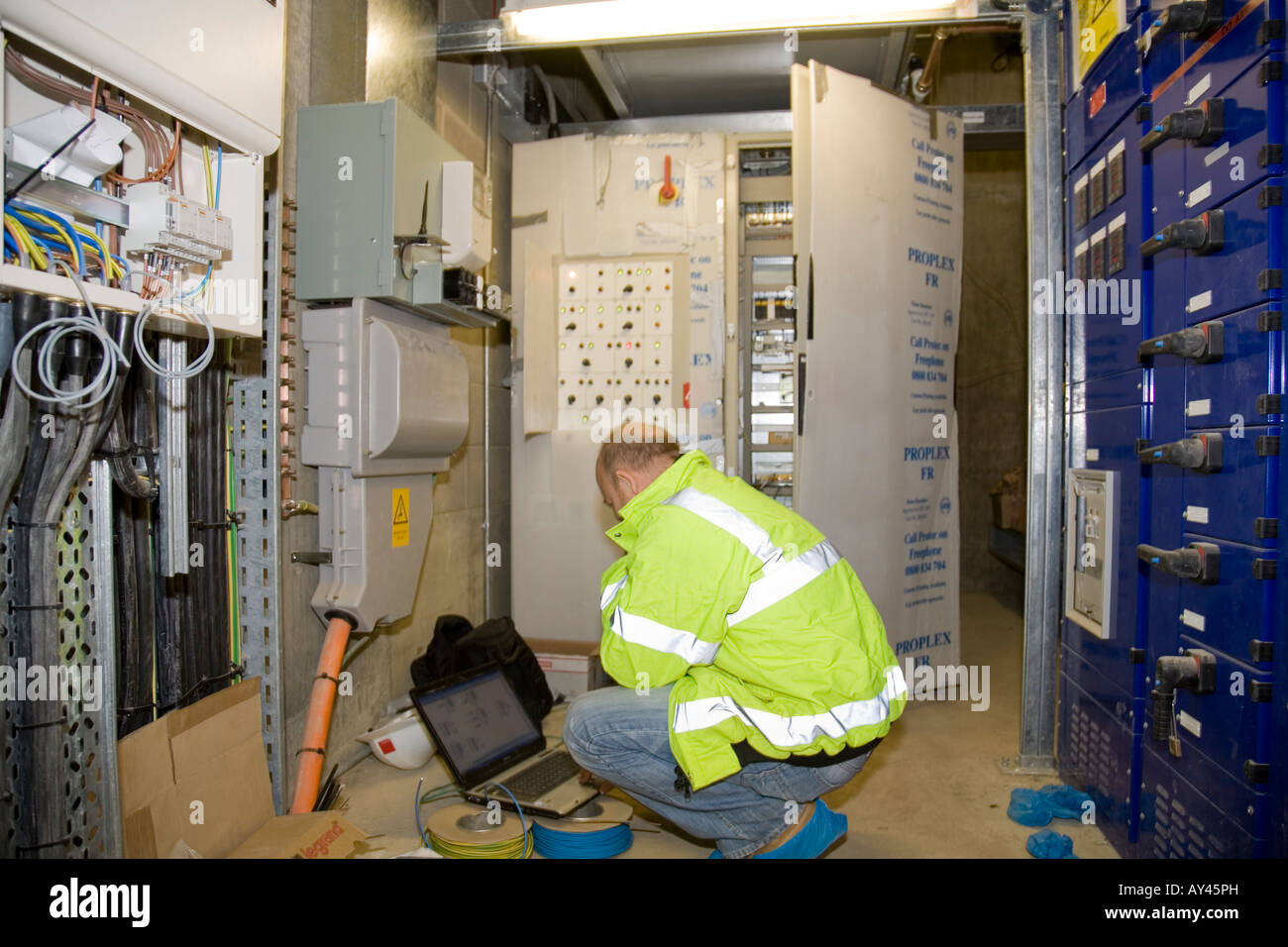 Electrical engineer reading electrical test meter in electrical service