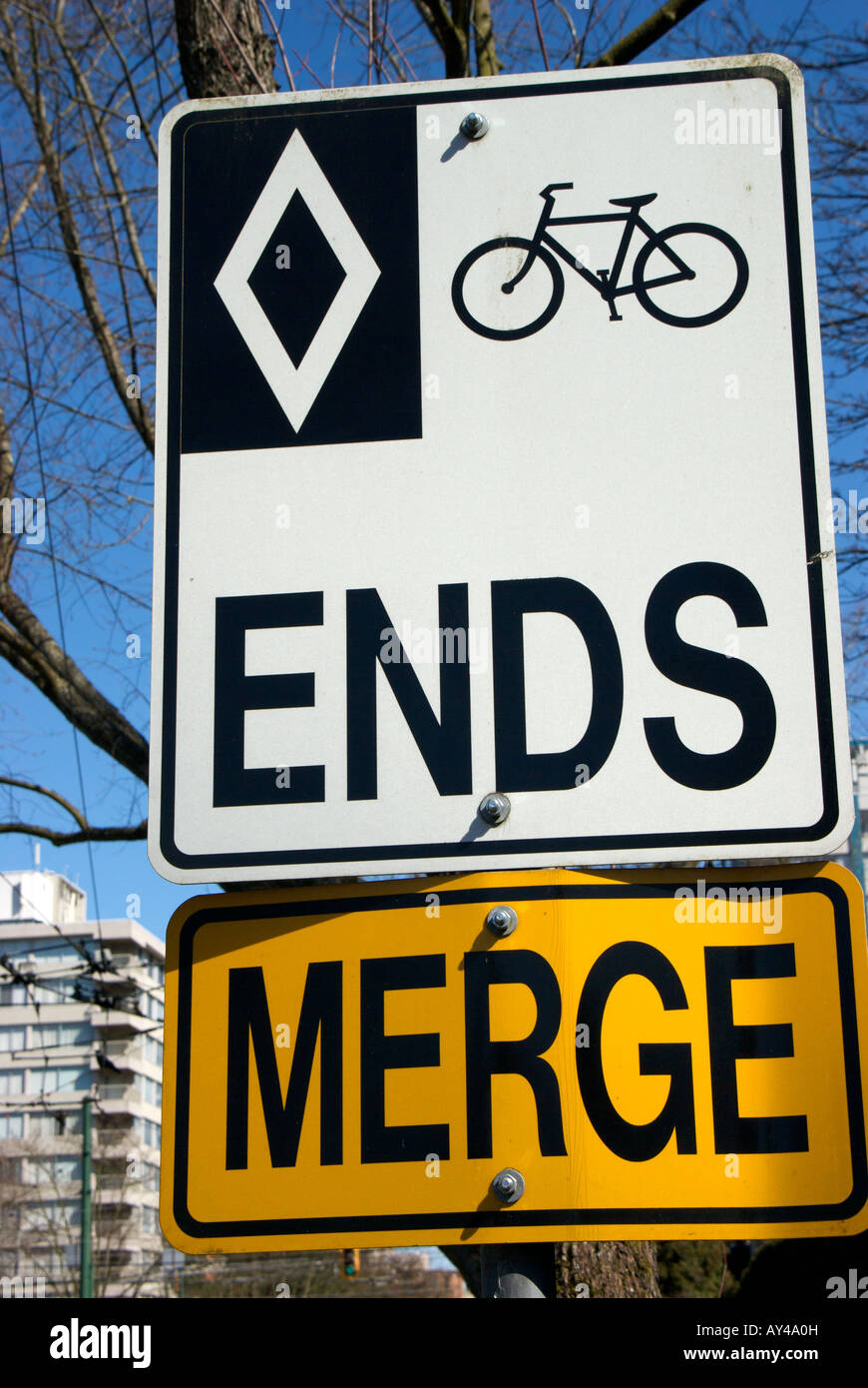 Bike and bus lane end sign with warning sign to merge Stock Photo
