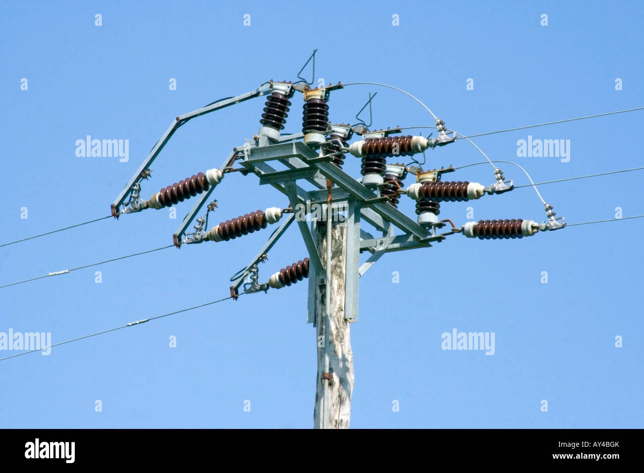 Electric power lines over clear blue sky Stock Photo - Alamy