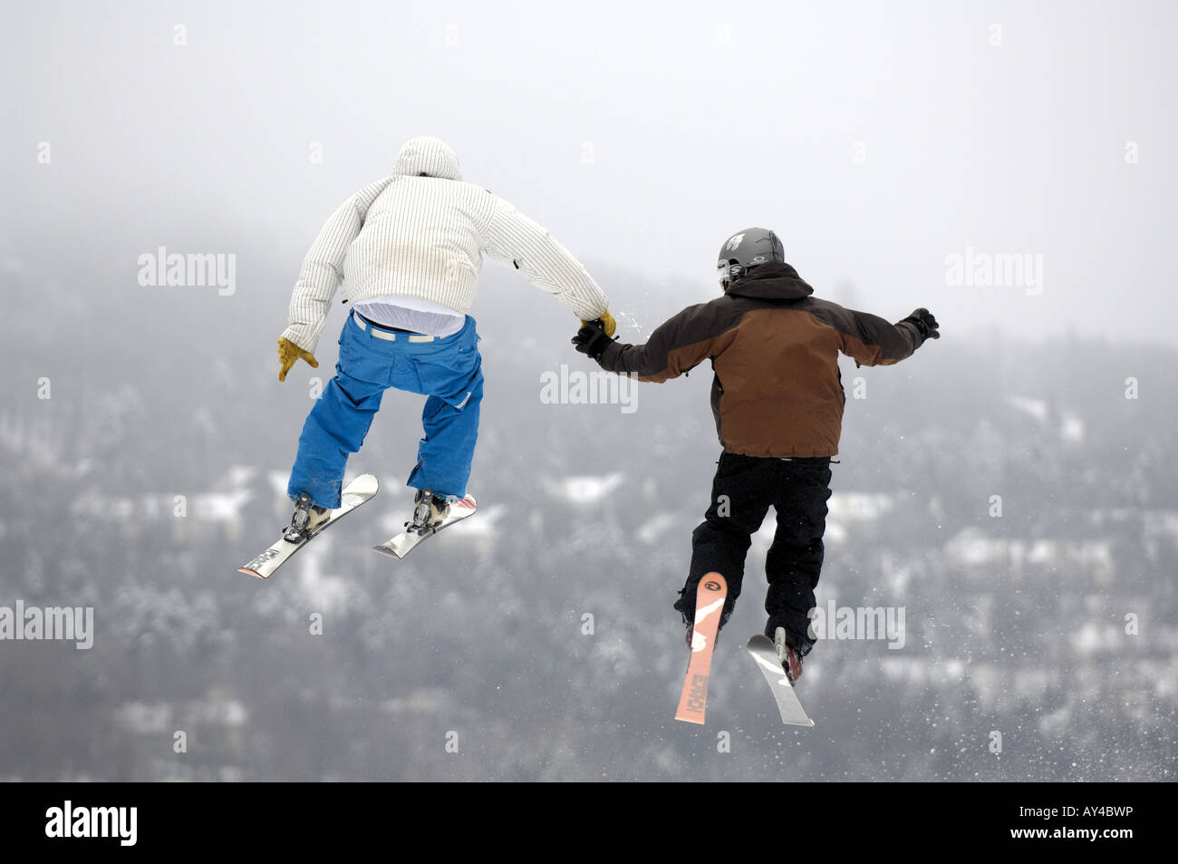 Two skiiers holding hands mid air Stock Photo - Alamy Two skiiers holding hands mid air Stock Photo - Alamy