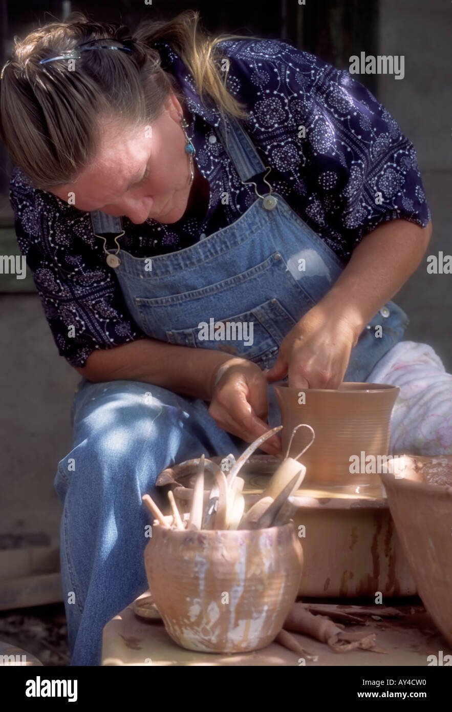 MR 0275 Ceramic pottery artist Judy Pekelsma works with clay to make a fine vase, in Capitan, New Mexico. Stock Photo