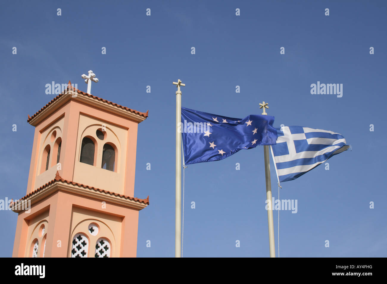 European and Greek flag at church in the mountain village Pano Hersonisos, Crete, Greece, Photo by Willy Matheisl Stock Photo