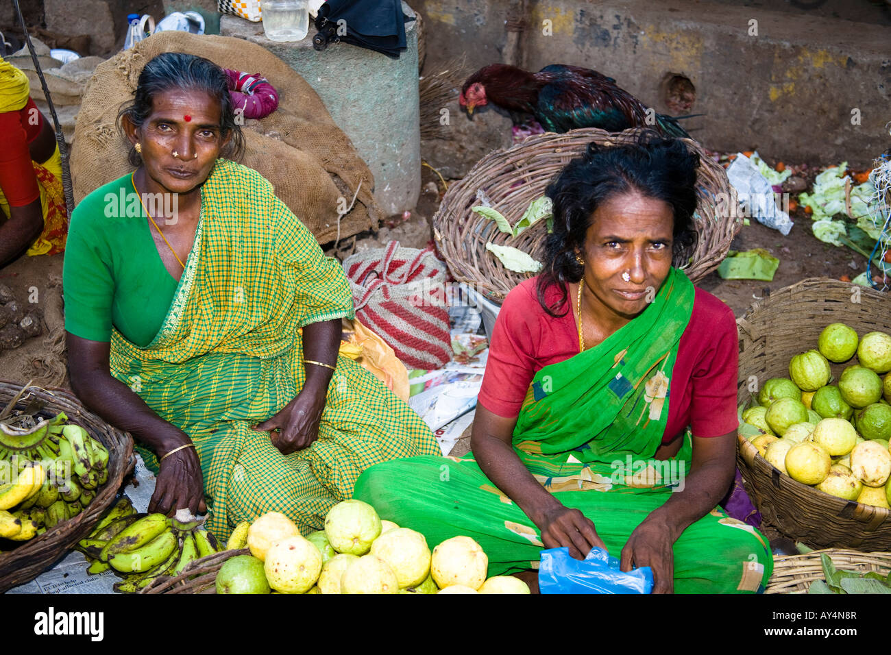 Two women selling fruit in a street market, Madurai, Tamil Nadu, India
