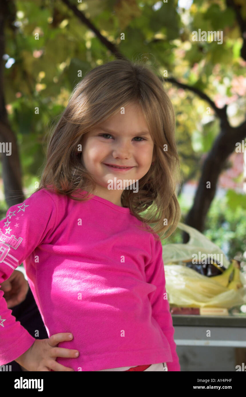 Little girl with blond hair outdoors smiling Stock Photo - Alamy
