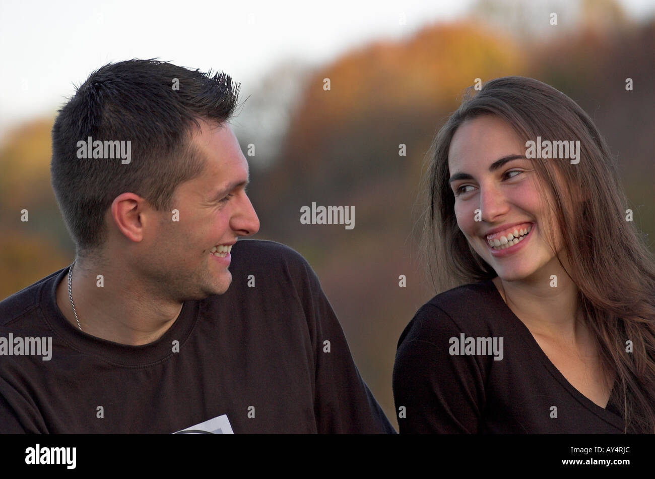 Young couple outdoors laughing Stock Photo