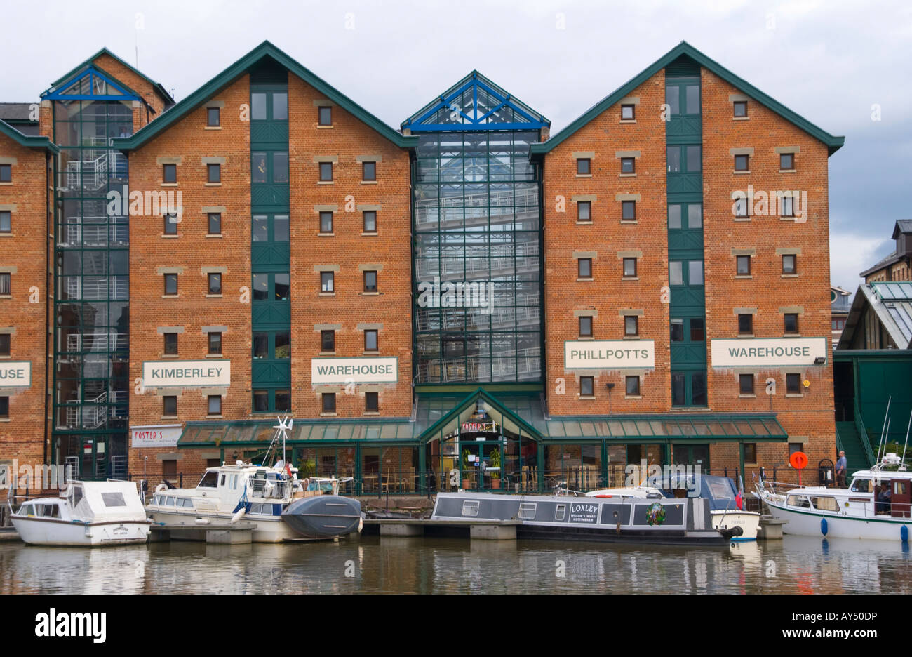 Former industrial warehouses now used for shops pub and offices at the docks in Gloucester Gloucestershire England UK EU Stock Photo