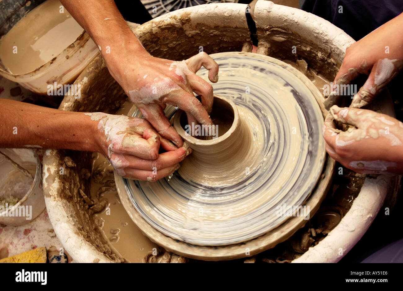 Hands throwing pot on pottery wheel Stock Photo Alamy