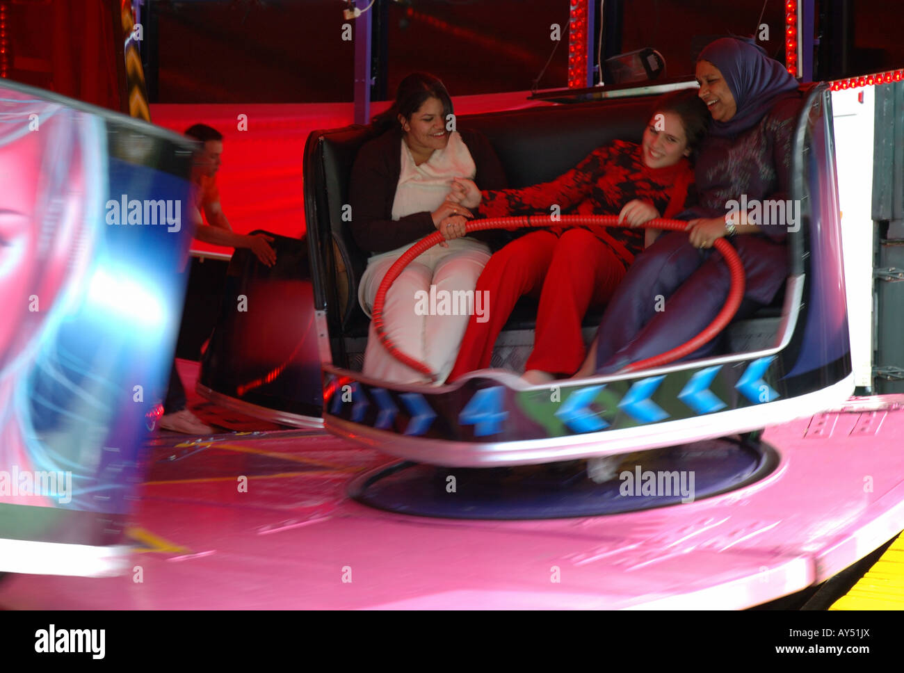 asian women on fairground ride, Leicester, England, UK Stock Photo