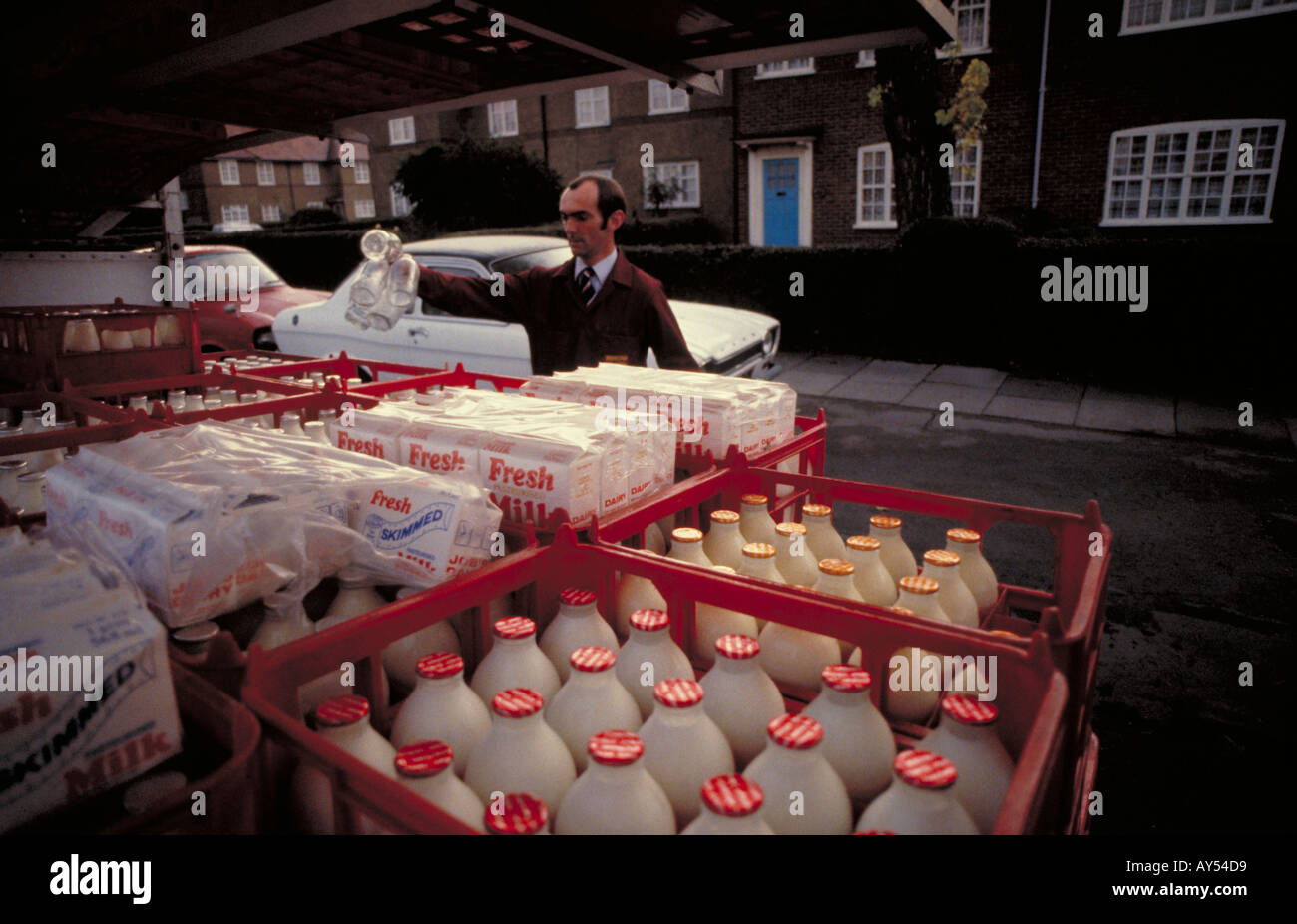 Milkman delivering milk early in the morning in West London from his