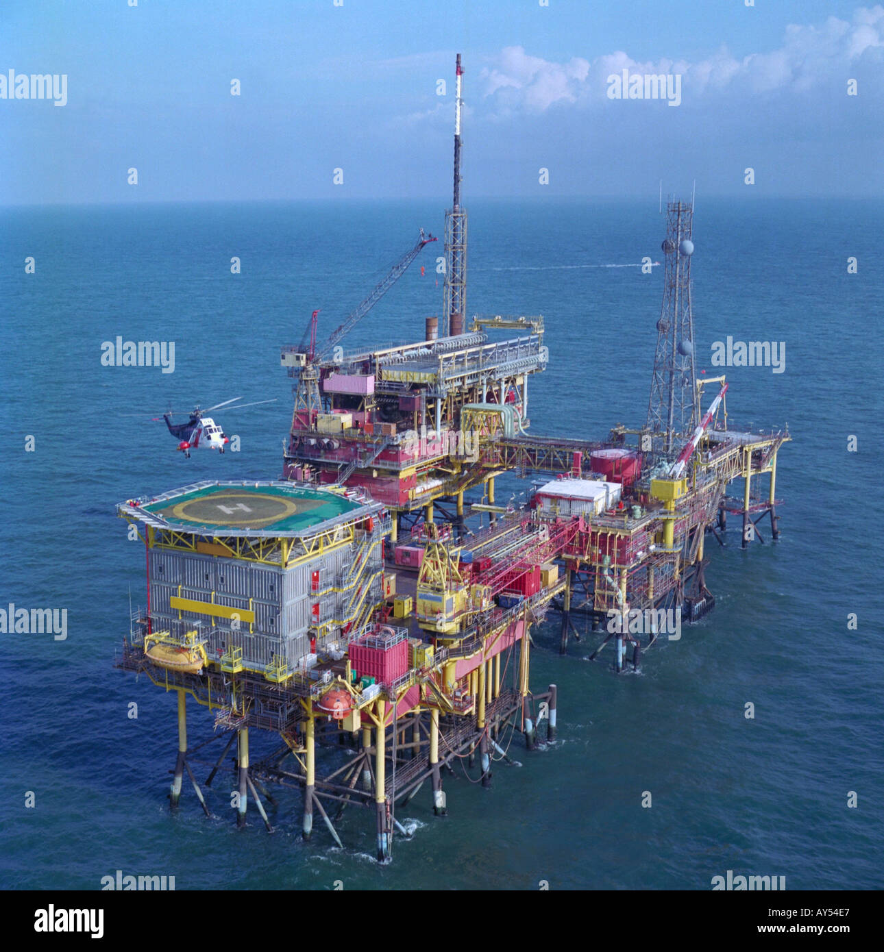 Service helicopter landing on aluminium landing pad at a gas production rig in North Sea Stock Photo
