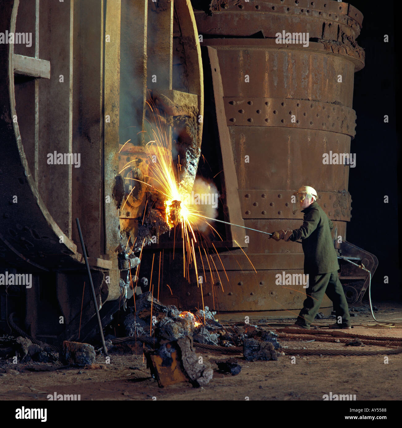 Removing slag at the tap hole of steel furnace ladle Stock Photo - Alamy