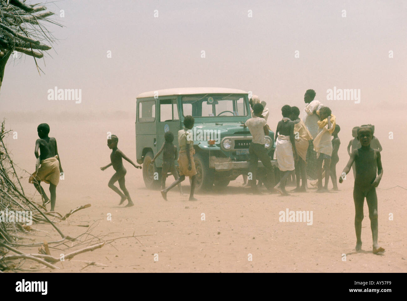 Choking dust surrounds a UN World Health Organisation vehicle near a