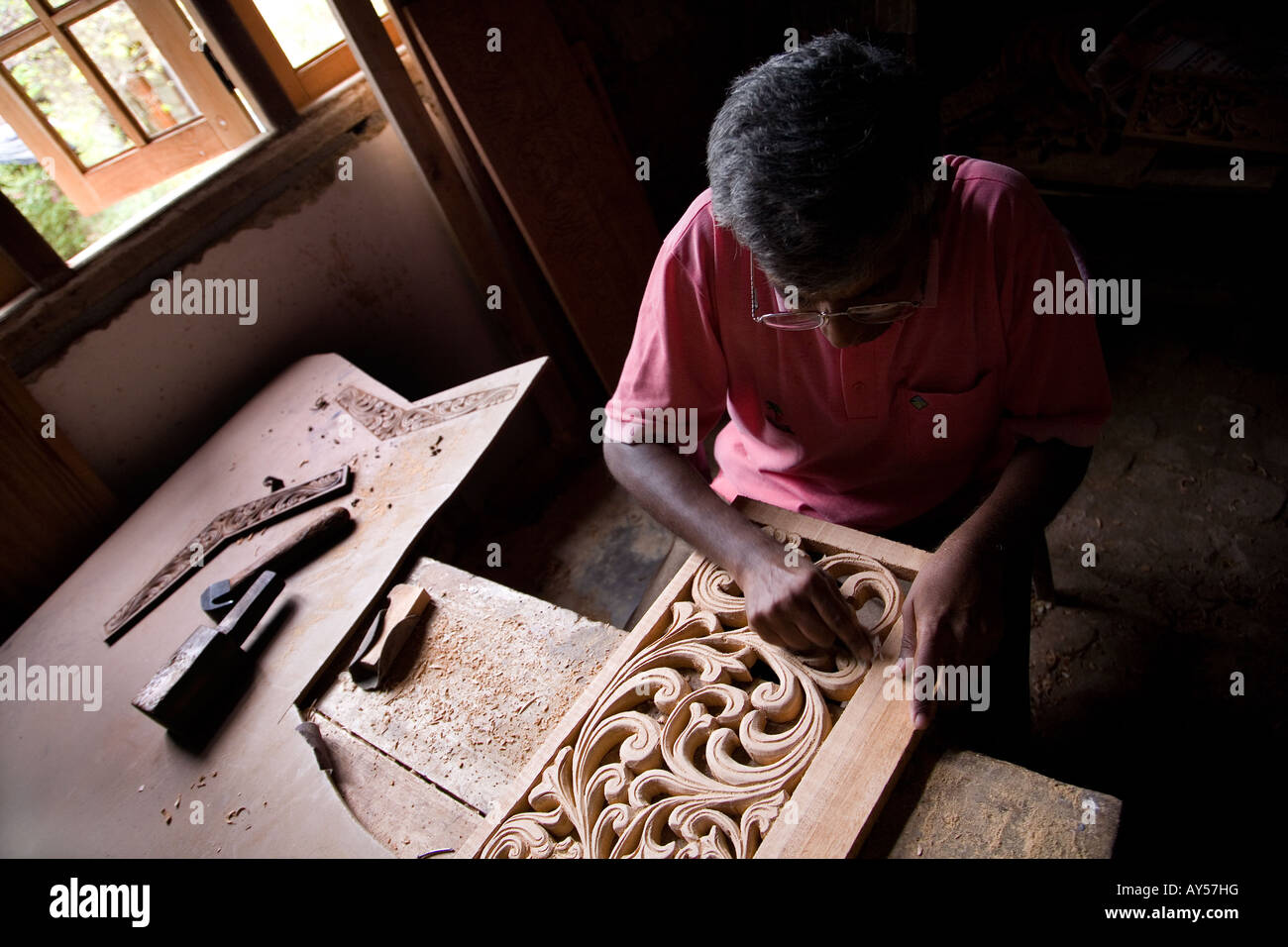 craftsman sculpting wood for traditional decoration Stock Photo Alamy