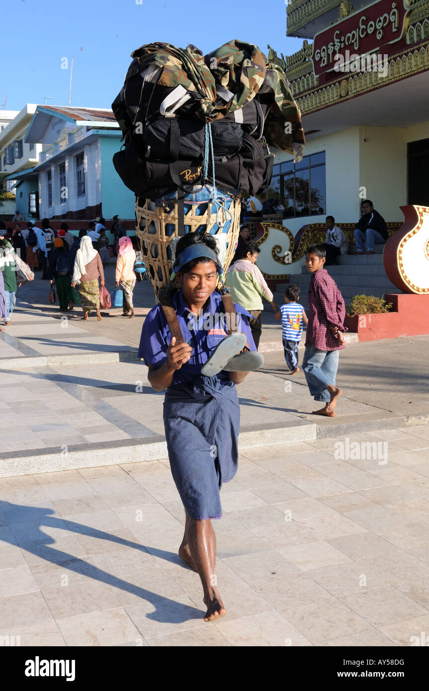 Porters transporting a lot of luggage down a hill the golden rock Kytiku  Myanmar Asia Stock Photo - Alamy