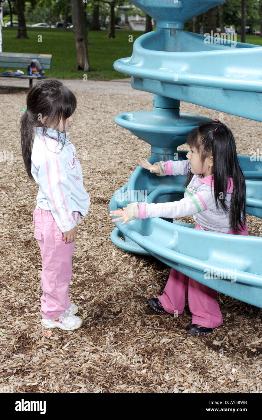 Two 4 year old girls talking on the playground Stock Photo