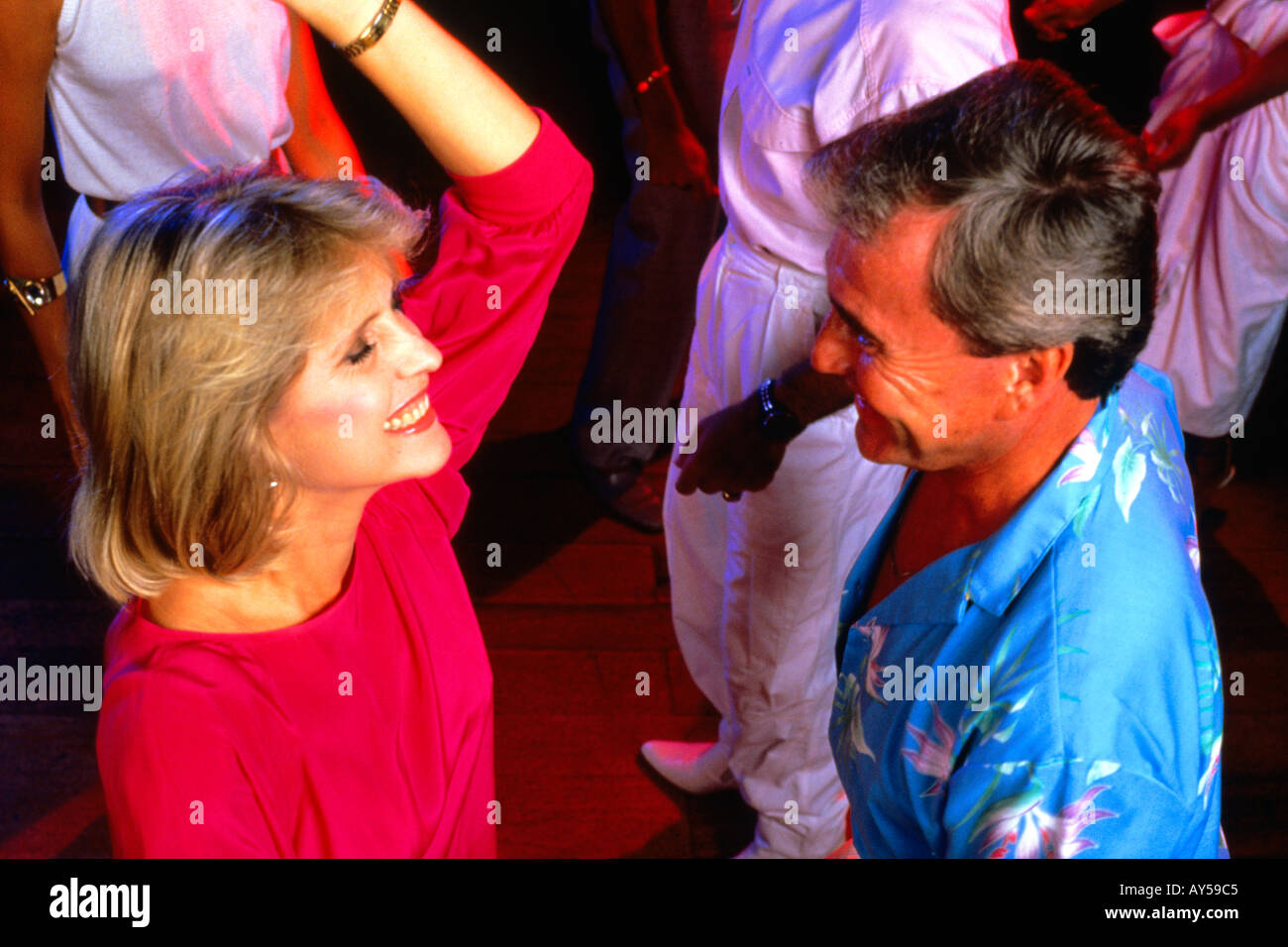 Couple 50s Dancing at a Caribbean Night Club Stock Photo