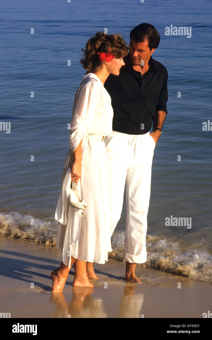 Romantic Couple Walking on Beach Stock Photo