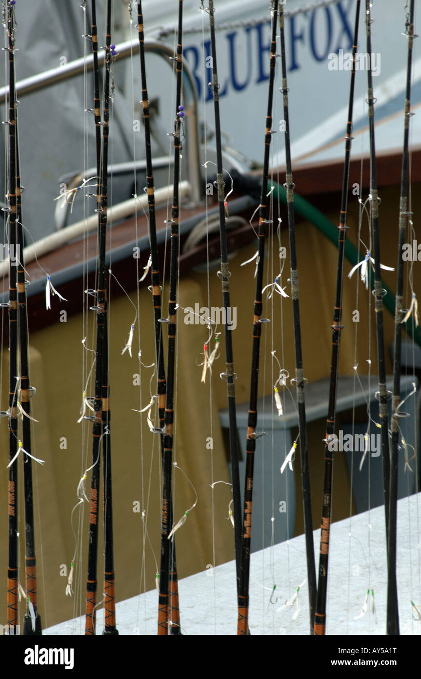 Cornwall Padstow harbour fishing rods on a boat waiting for tourists to go sport fishing Stock Photo