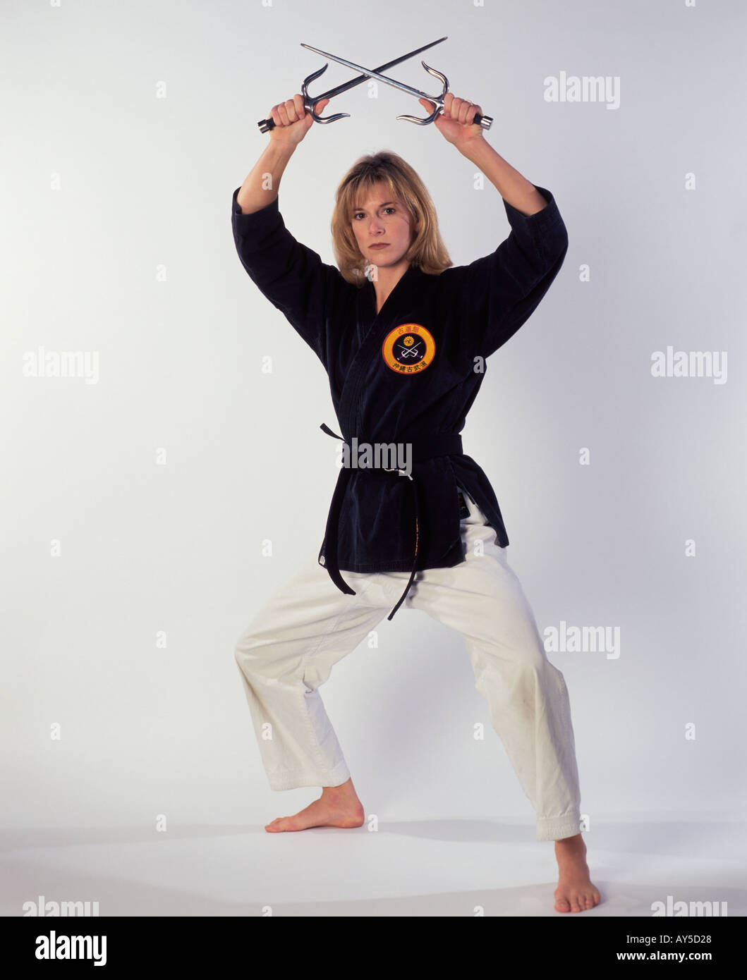 woman black belt with ancient weapons Stock Photo