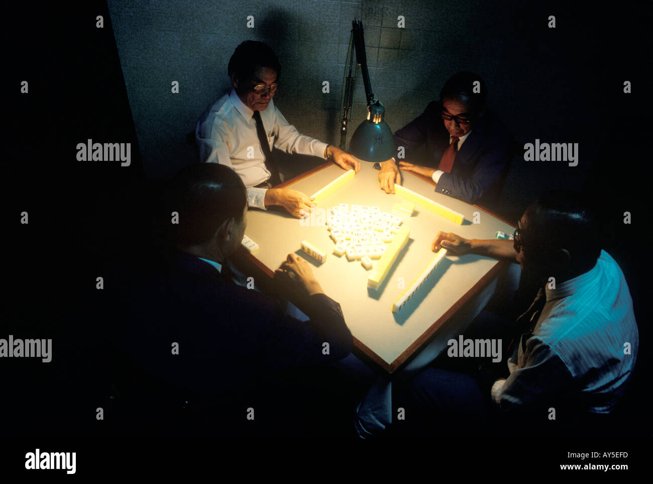 Mahjong Hong Kong China men playing after work late into the night 1990s 11991 China  HOMER SYKES Stock Photo