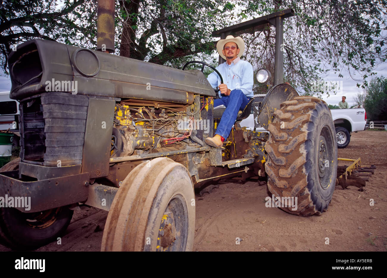 A cowboy fires up the grounds-grooming tractor, at the annual 4-H Rodeo ...
