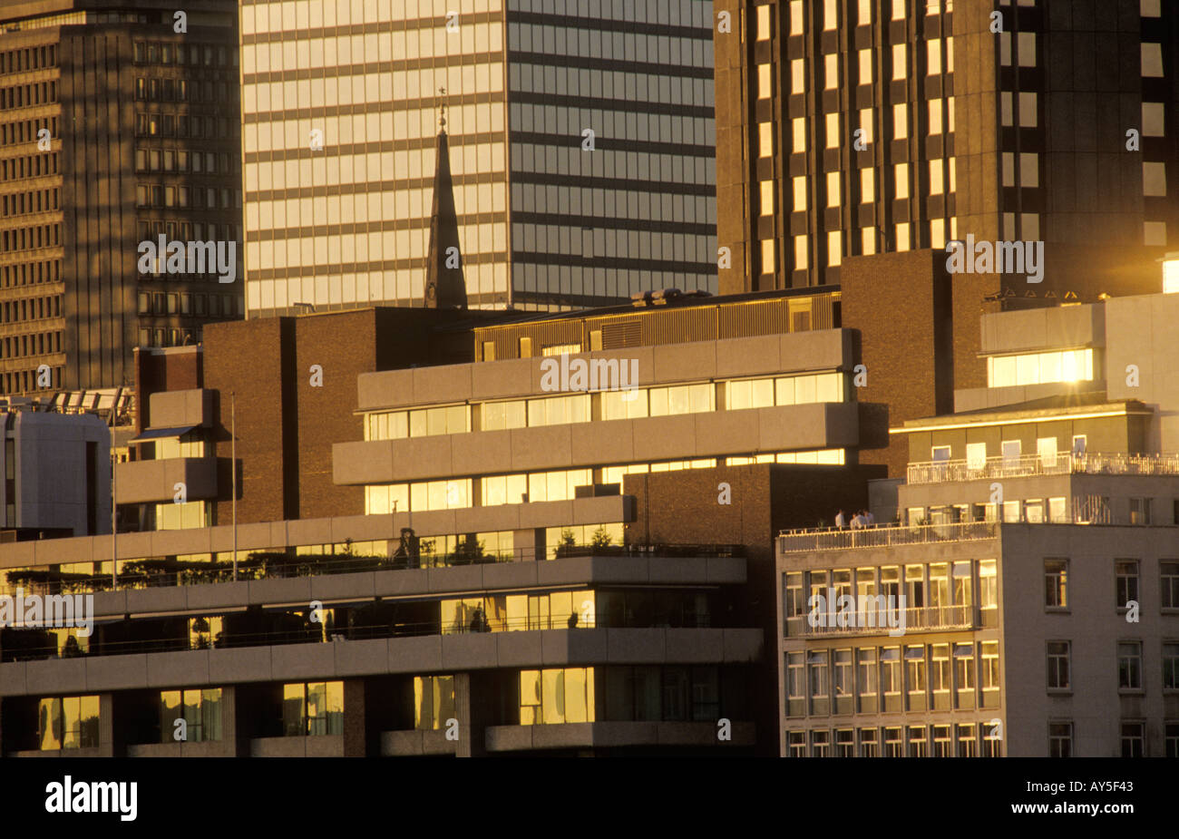 City of London new 1990s office blocks tower over an ancient church  spire contrasting the new and the old.1992 HOMER SYKES Stock Photo