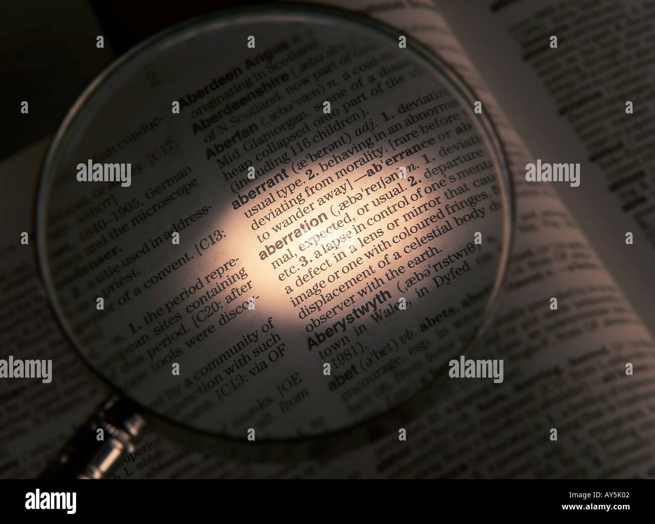 magnifying-glass-on-dictionary-page-showing-definition-of-the-word