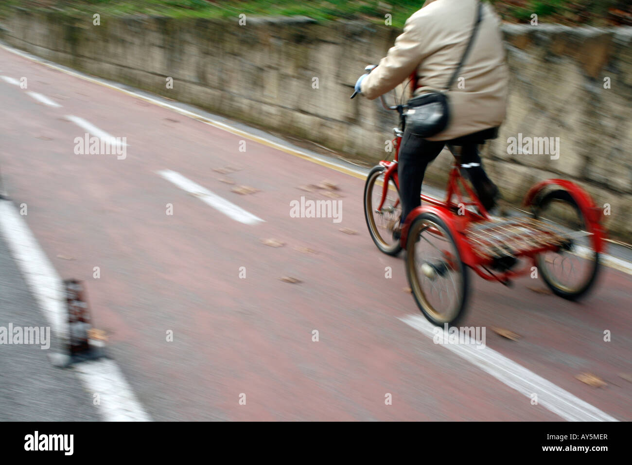 Woman female old trike tricycle three wheels red adult hires stock