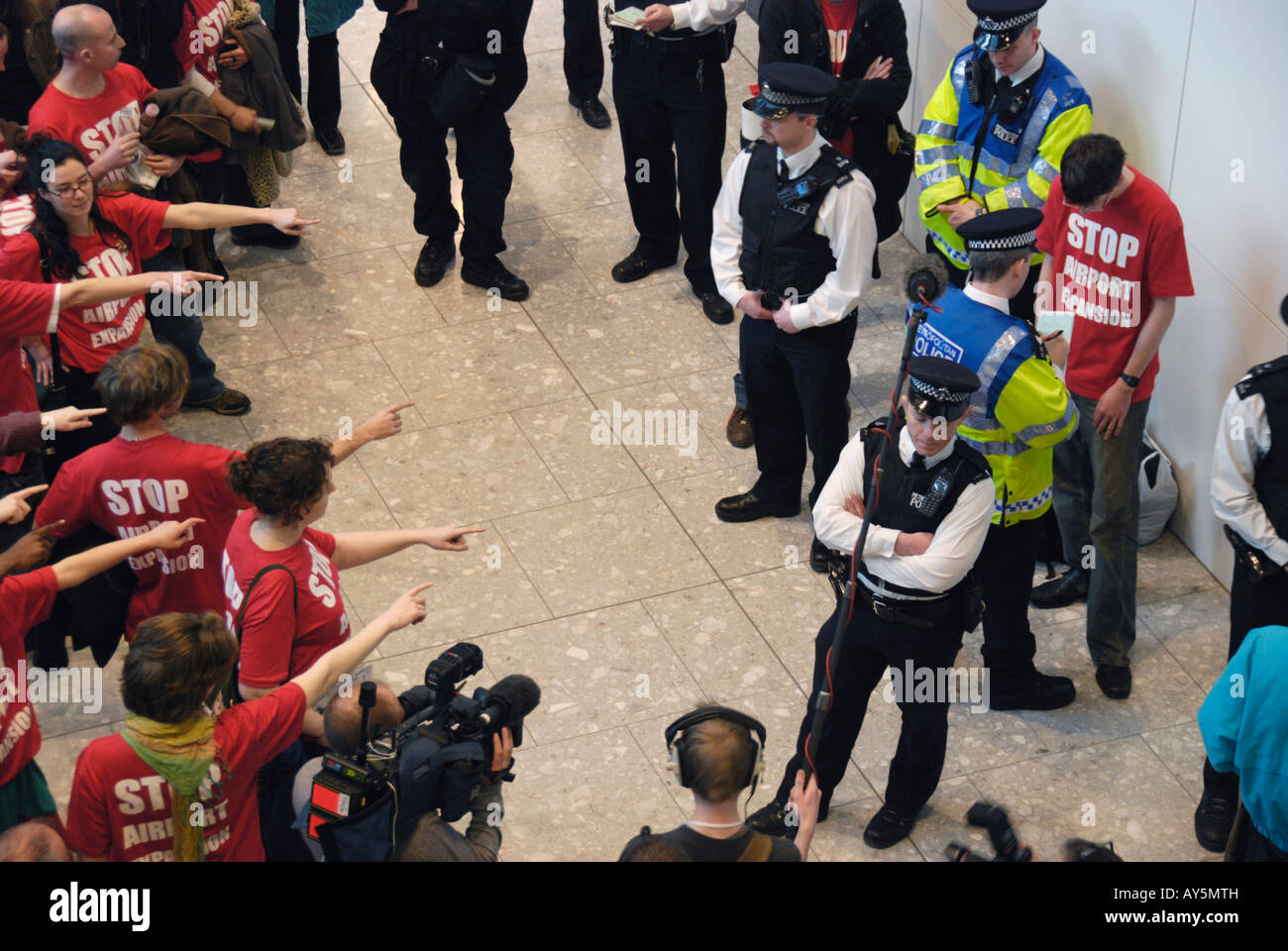 Stop Airport Expansion protesters and police at Heathrow Terminal 5 London Stock Photo