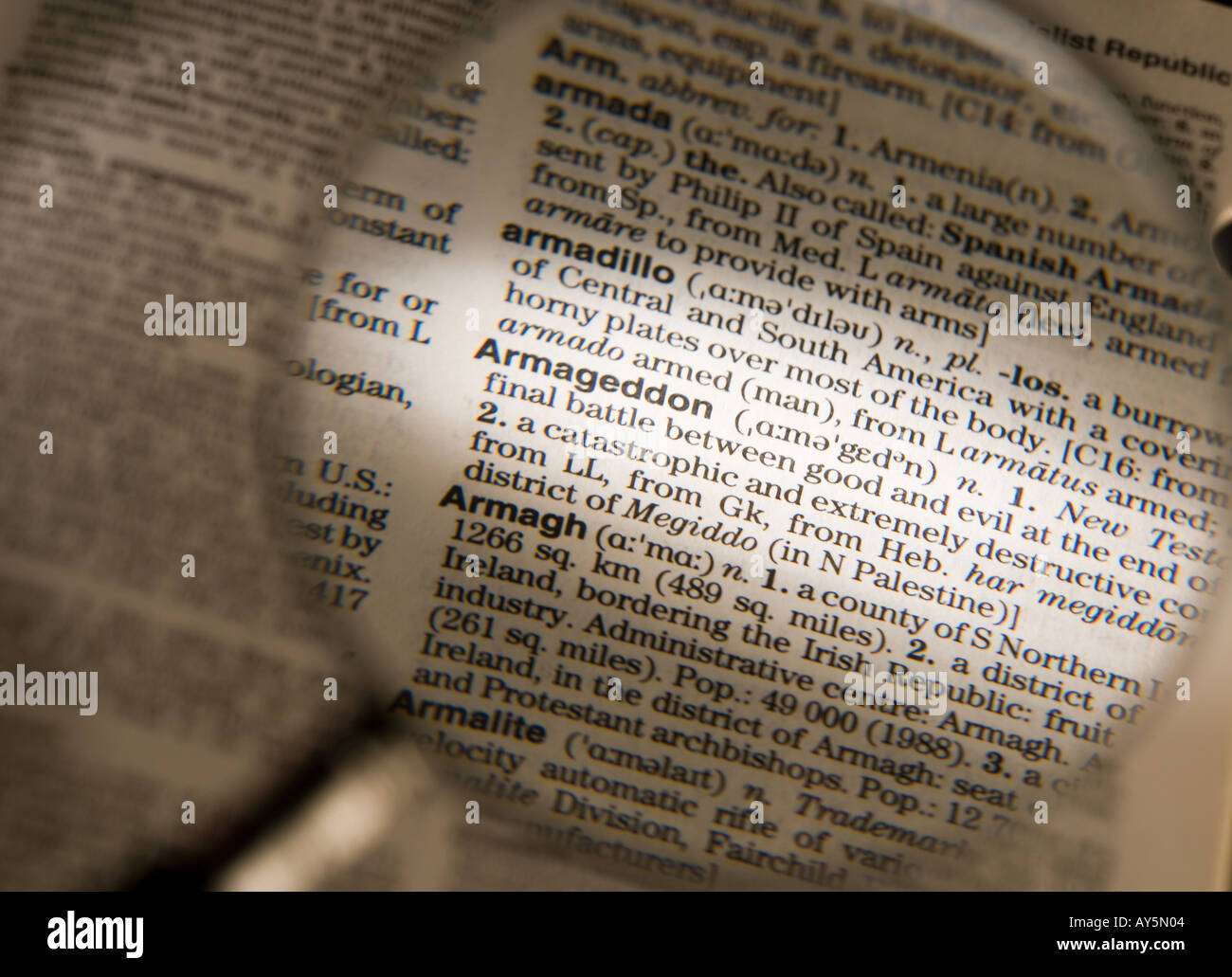 MAGNIFYING GLASS ON DICTIONARY PAGE SHOWING DEFINITION OF THE WORD