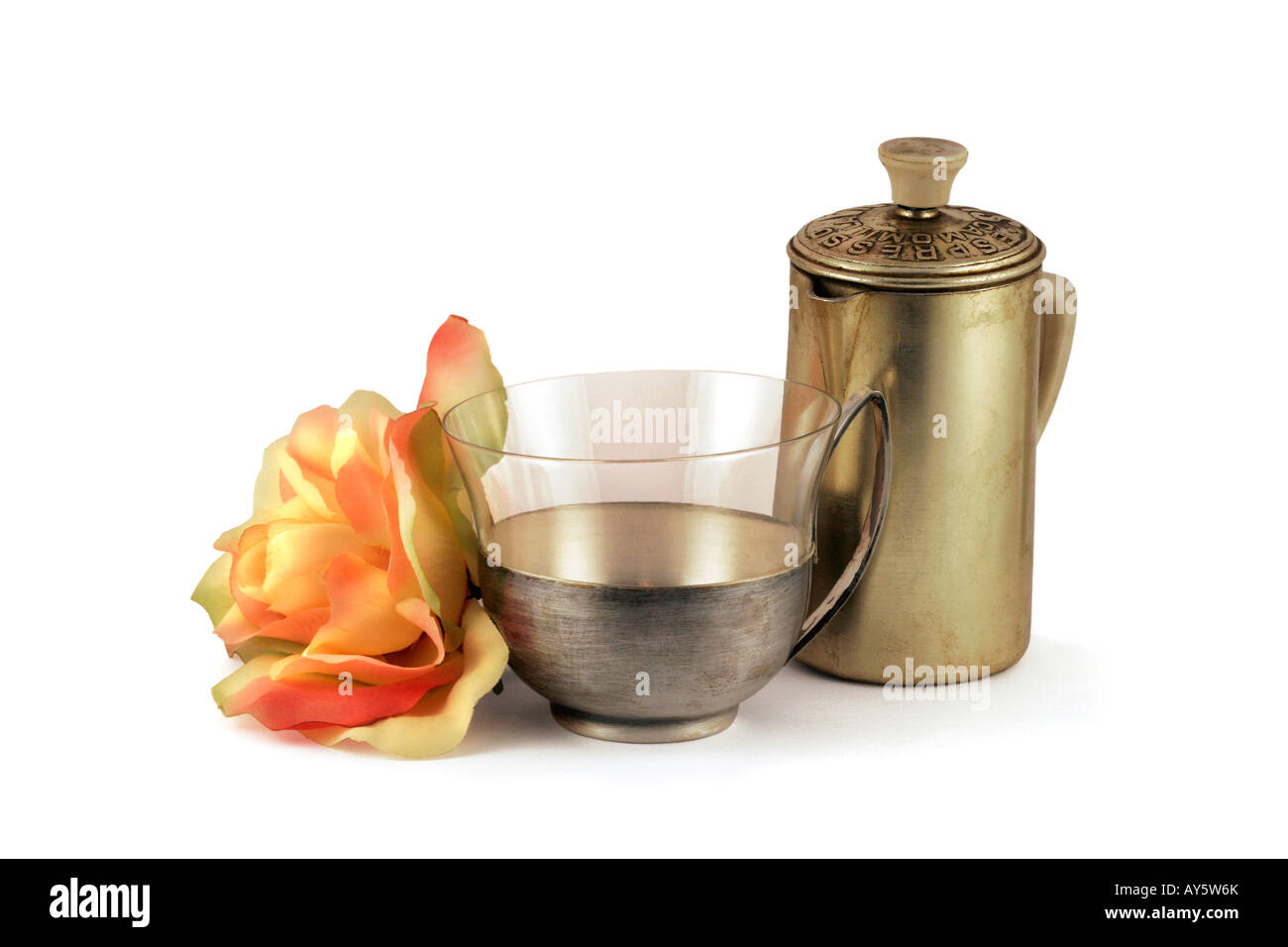 A still life with old-fashion: ancient italian objects. A silver-glass tea cup, an aluminium coffee-jug and a gentle flower. Stock Photo