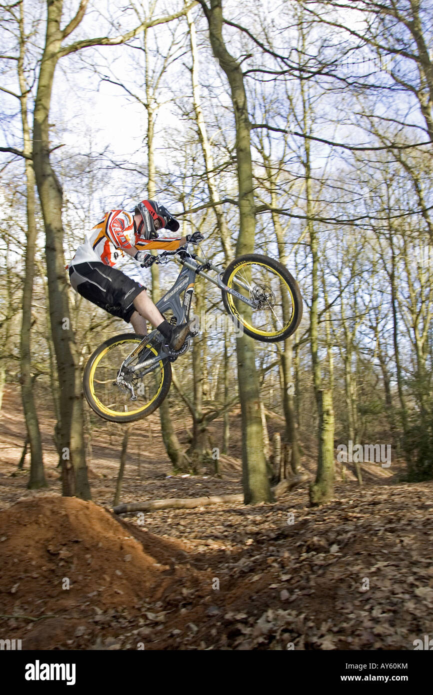 A mountain biker jumps his mountain bike over a dirt jump Stock Photo Alamy