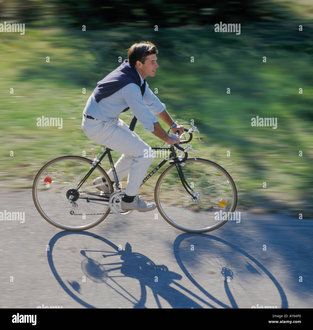 man riding bicycle in park Stock Photo