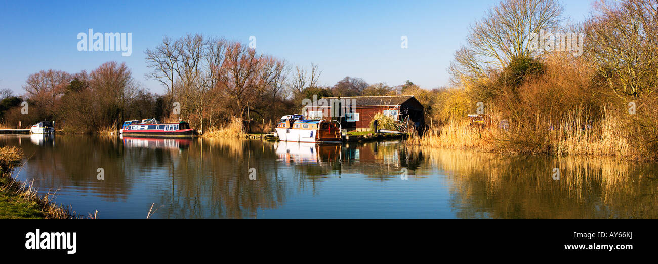 Winter Colours On The River Ouse A Cottage With A Moored Boat Alongside, The River Ouse Houghton Cambridgeshire England UK Stock Photo