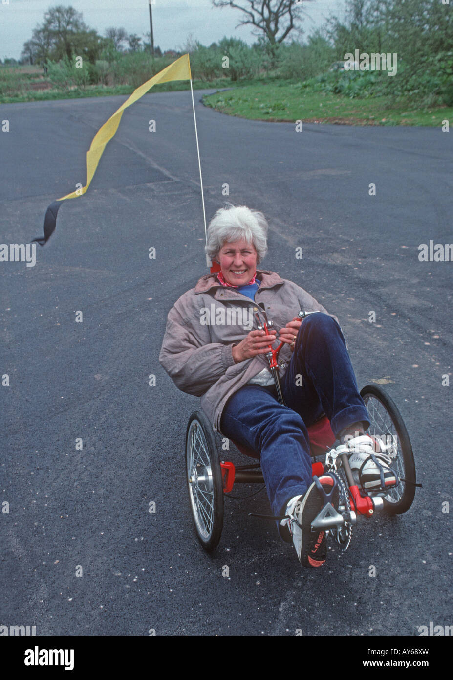 Woman riding recumbent tricycle on road UK Stock Photo Alamy