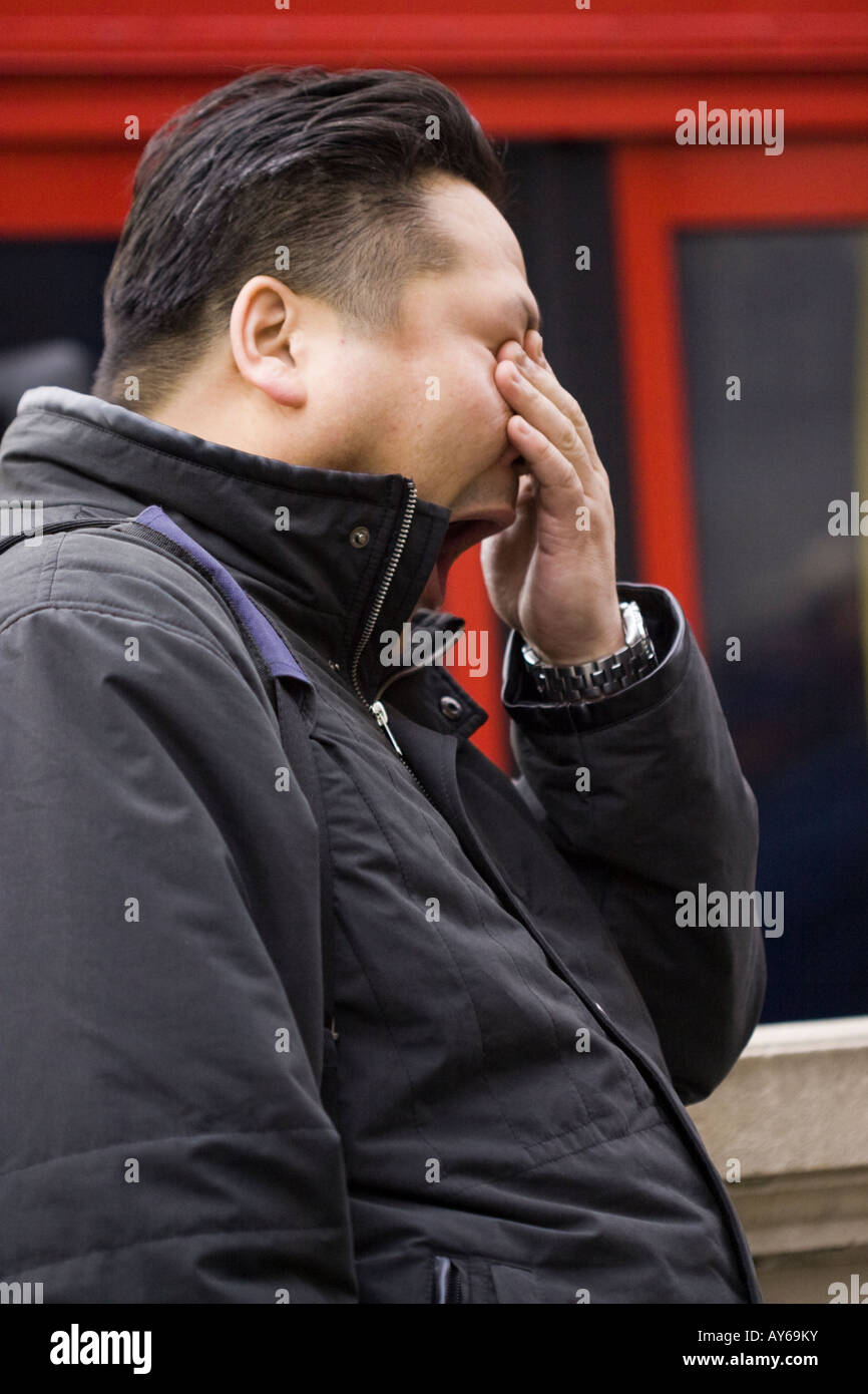 Tired man on street near Oxford Circus London Stock Photo