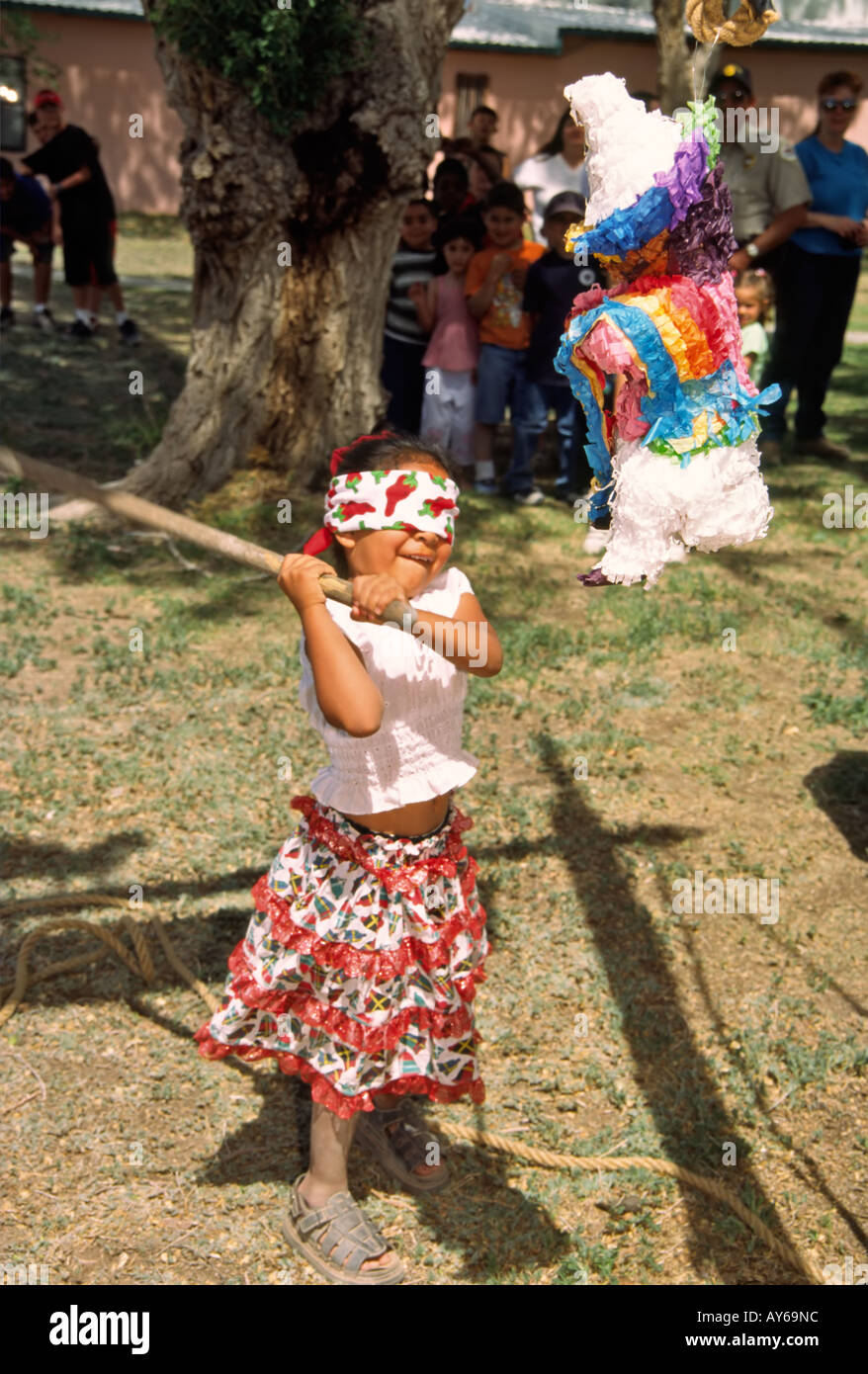 With a mighty swing, a young Hispanic girl tries to break the pinata, at  the Cinco de Mayo fiesta in Carrizozo, New Mexico Stock Photo - Alamy