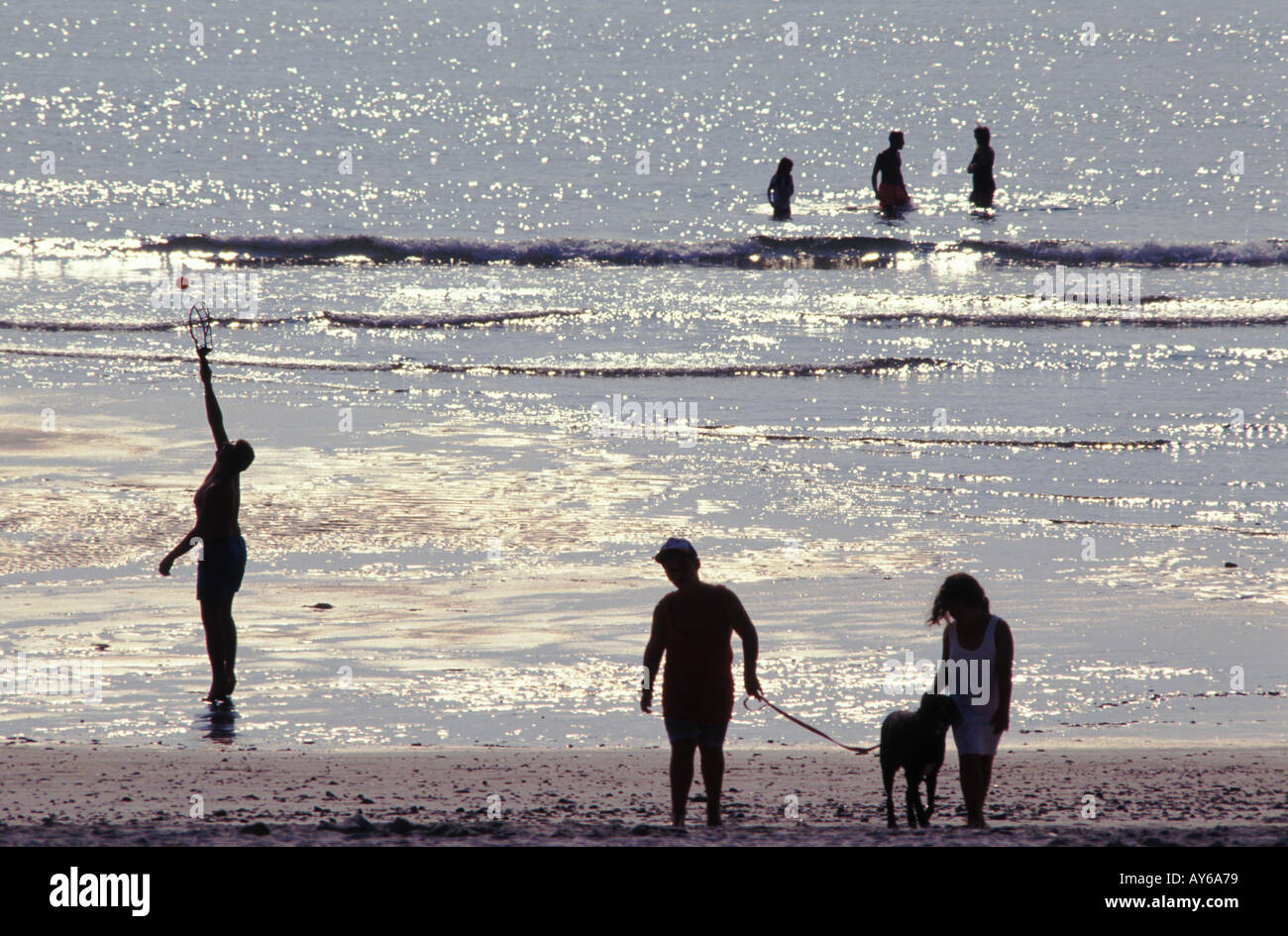 Various beach activities in silhouette Stock Photo