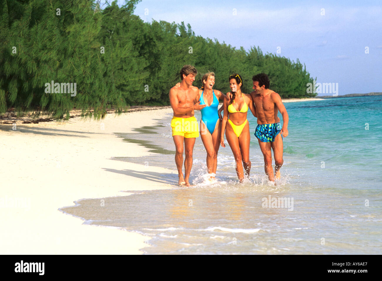 Vacationing Couples Having Fun on Caribbean Beach Stock Photo
