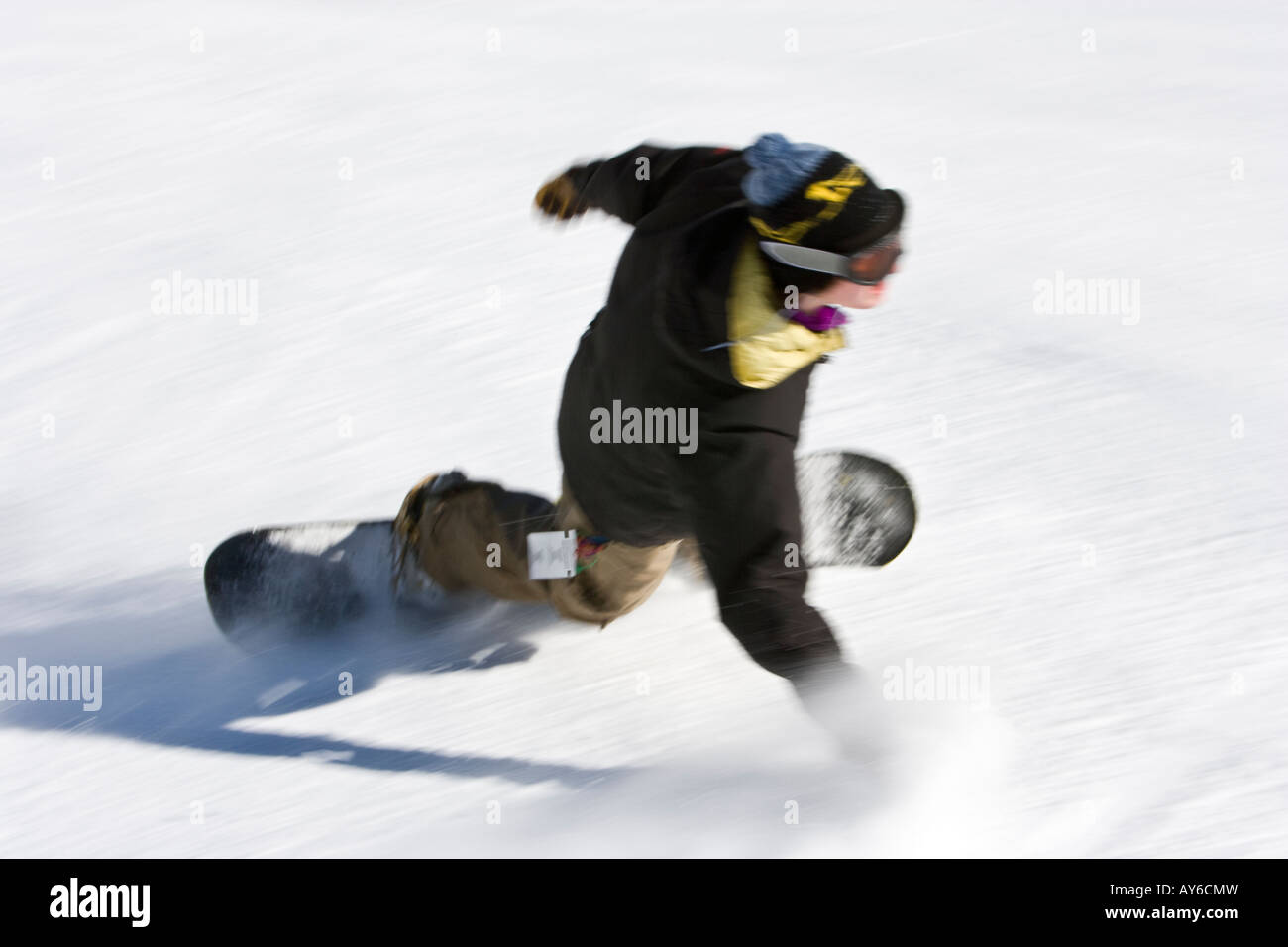James flies down Baldy Mountain in a blur snowboarding on a winters day Stock Photo