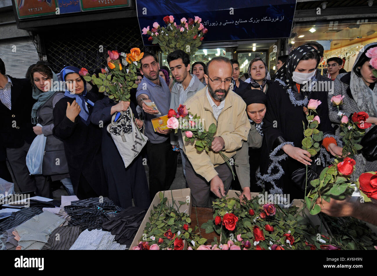 Iranian people buying flowers at an outdoor market ahead of the solar new year 'Nowruz' celebrations in Tehran, Iran Stock Photo
