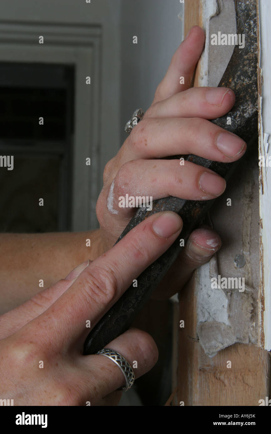 Woman's hands using chisel to remove plaster from wall Stock Photo Alamy
