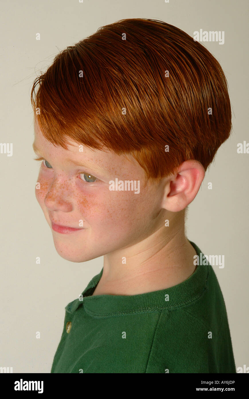 A 5 year old red headed Caucasian boy in a green shirt from Southern California MODEL RELEASE Stock Photo