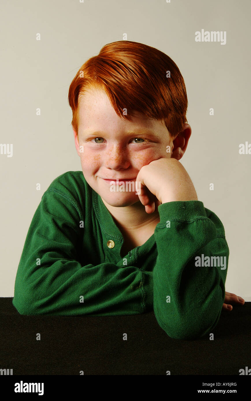 A 5 year old red headed Caucasian boy in a green shirt from Southern California MODEL RELEASE Stock Photo