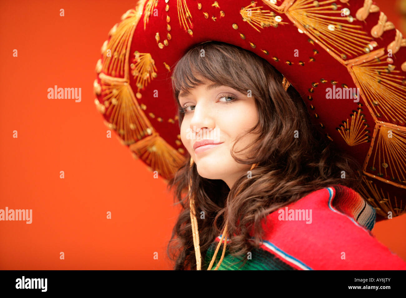 Mexican woman wearing traditional hat hi-res stock photography and